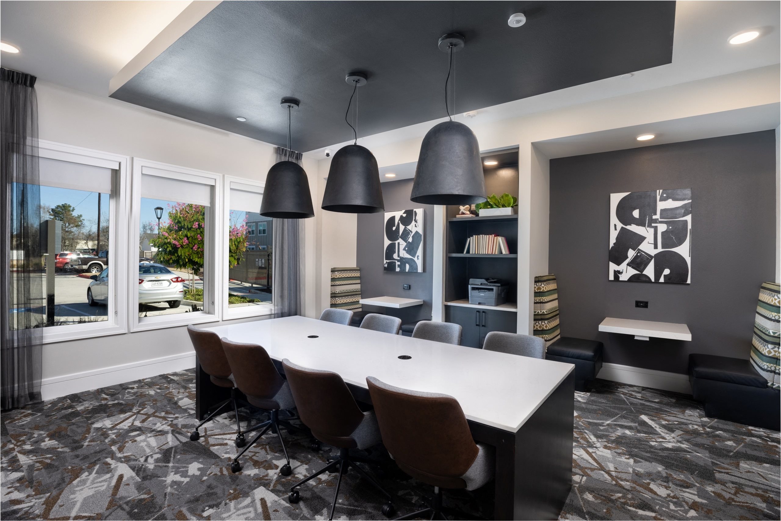 a conference room with a white table and chairs and a window